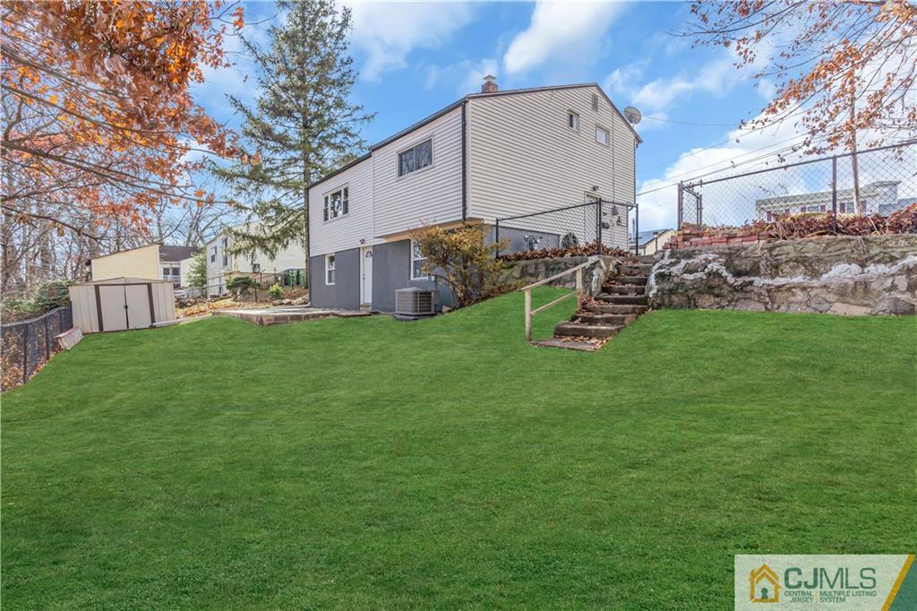 9 Nancy Circle Edison, NJ 08817 - Photo 38 of 38 a view of a backyard with table and chairs and a slide