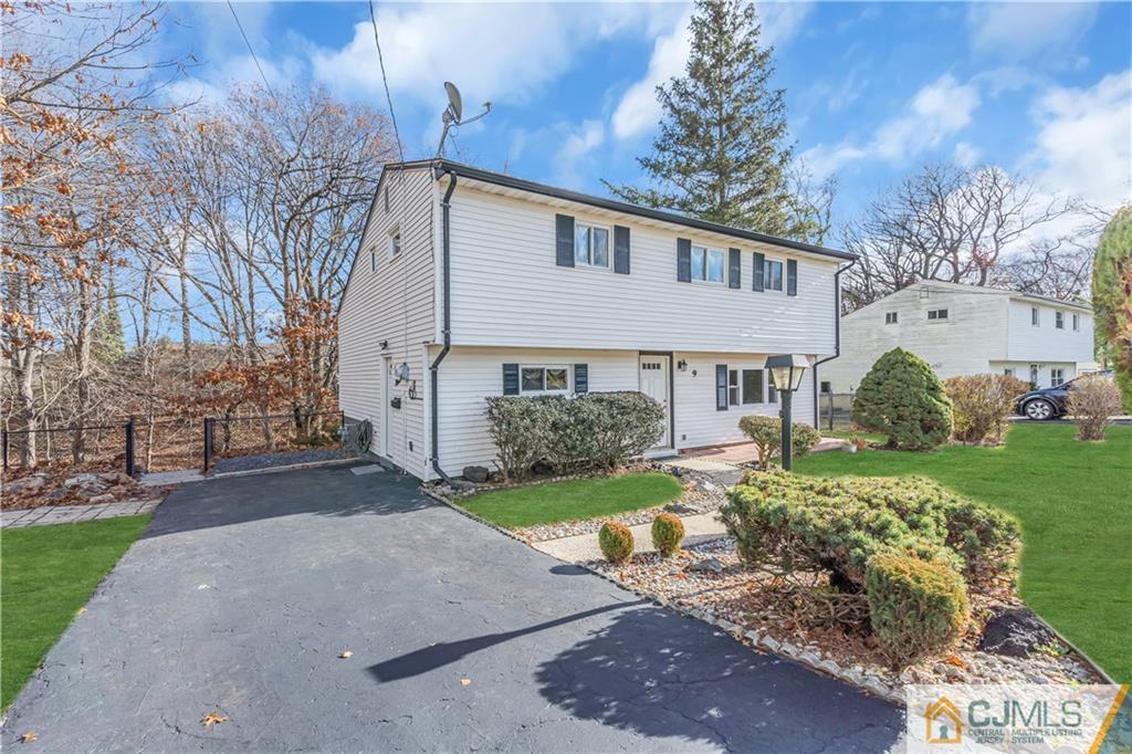 9 Nancy Circle Edison, NJ 08817 - Photo 6 of 38 a front view of a house with a yard and garage