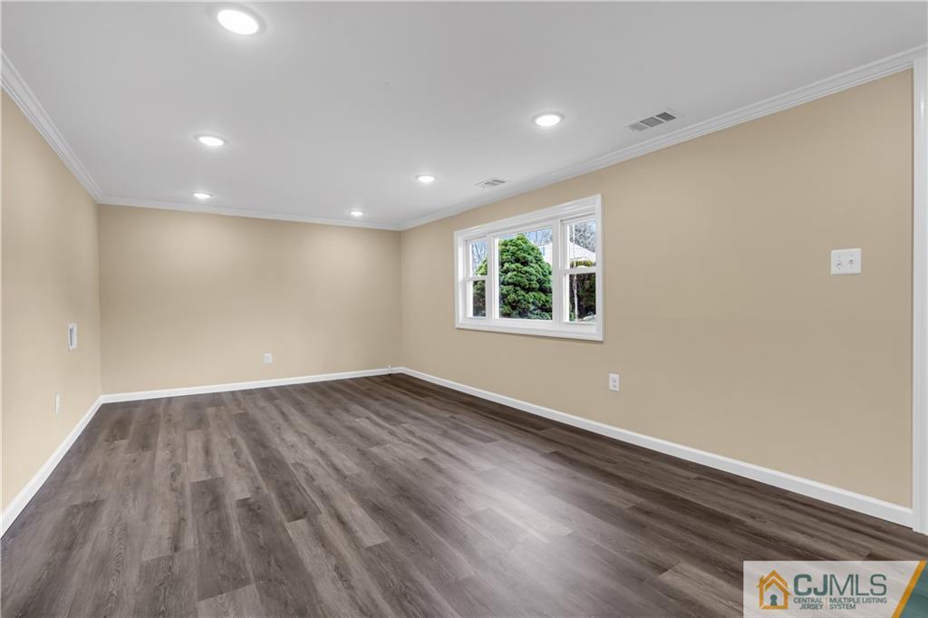 9 Nancy Circle Edison, NJ 08817 - Photo 8 of 38 an empty room with wooden floor and windows