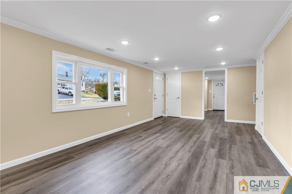 9 Nancy Circle Edison, NJ 08817 - Photo 9 of 38 a view of an empty room with wooden floor and a window