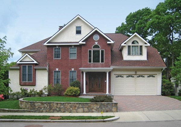 a front view of a house with a yard and garage