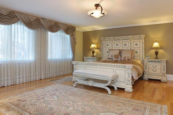 151 Bellingham Road Brookline, MA 02467 - Photo 8 of 14 a bedroom with a bed and a chandelier