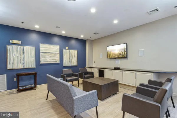 a living room with furniture a large window and a flat screen tv