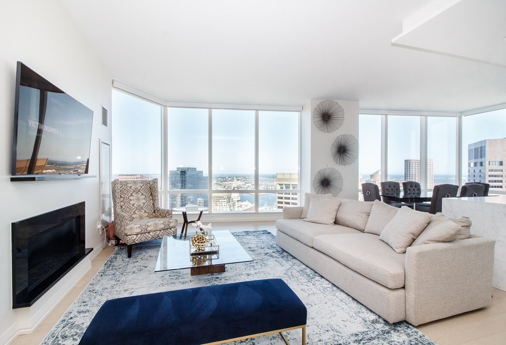1 Franklin Street, Unit 5205 Boston, MA 02110 - Photo 1 of 40 a living room with fireplace furniture and a flat screen tv