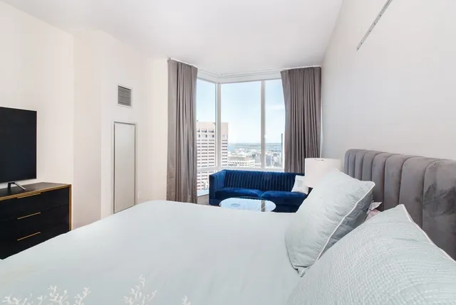 a bedroom with a bed and a flat screen tv