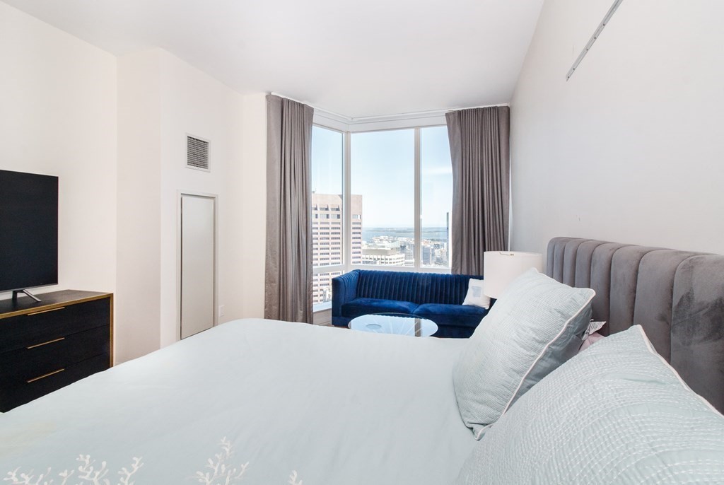 1 Franklin Street, Unit 5205 Boston, MA 02110 - Photo 11 of 40 a bedroom with a bed and a flat screen tv