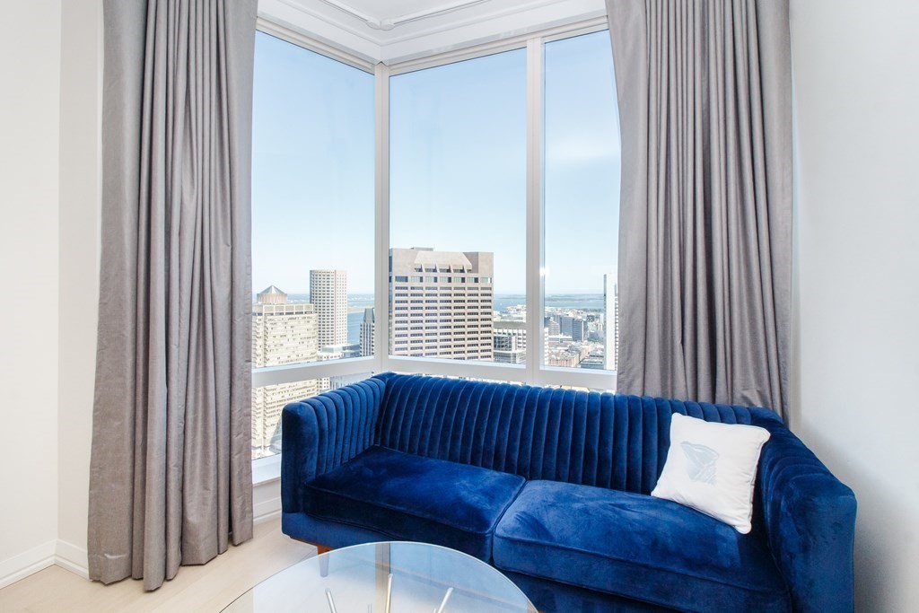 1 Franklin Street, Unit 5205 Boston, MA 02110 - Photo 12 of 40 a living room with furniture and a window