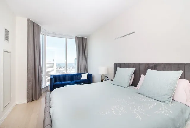 a bedroom with a large bed and a large window