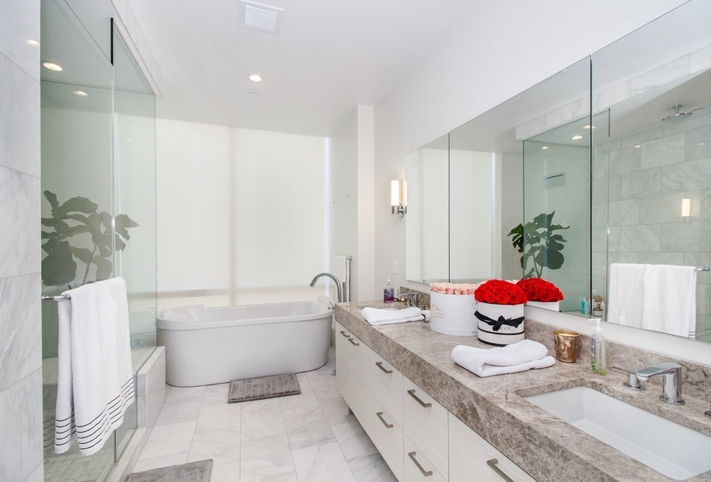 1 Franklin Street, Unit 5205 Boston, MA 02110 - Photo 14 of 40 a spacious bathroom with a double vanity sink mirror and bathtub