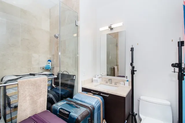 a bathroom with a sink toilet and mirror