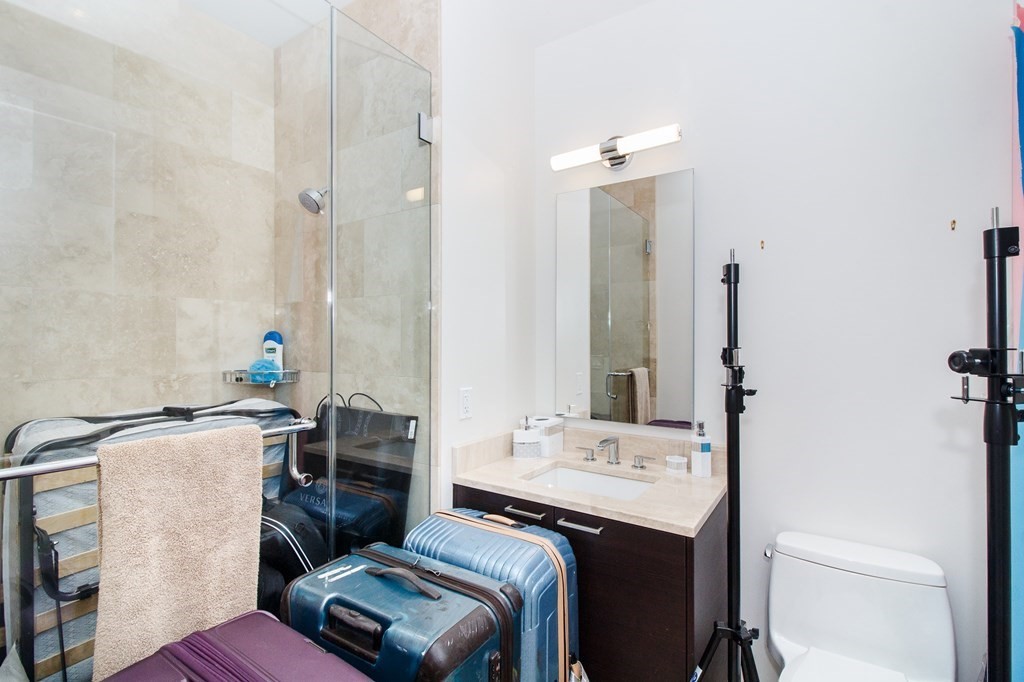 1 Franklin Street, Unit 5205 Boston, MA 02110 - Photo 18 of 40 a bathroom with a sink toilet and mirror