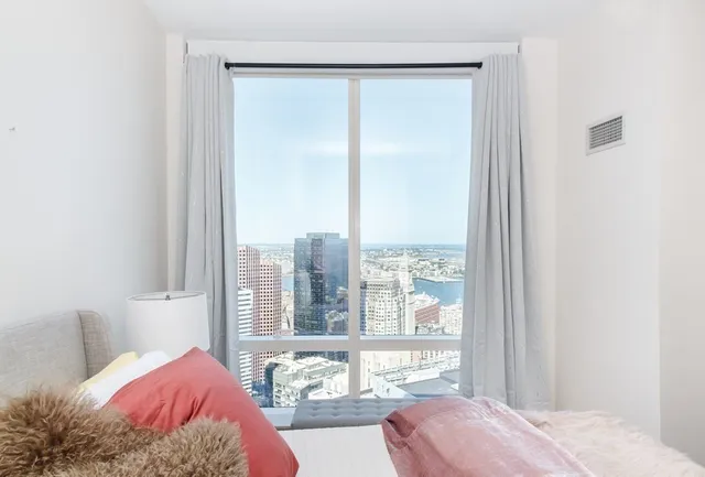 a view of a bedroom with a bed and glass door