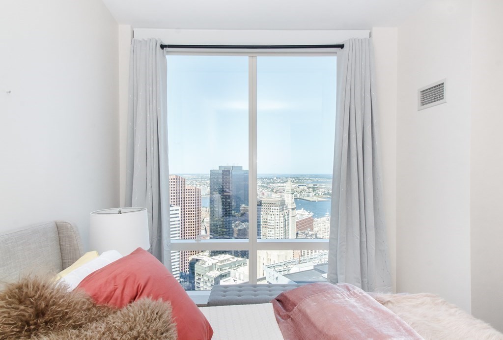 1 Franklin Street, Unit 5205 Boston, MA 02110 - Photo 20 of 40 a view of a bedroom with a bed and glass door