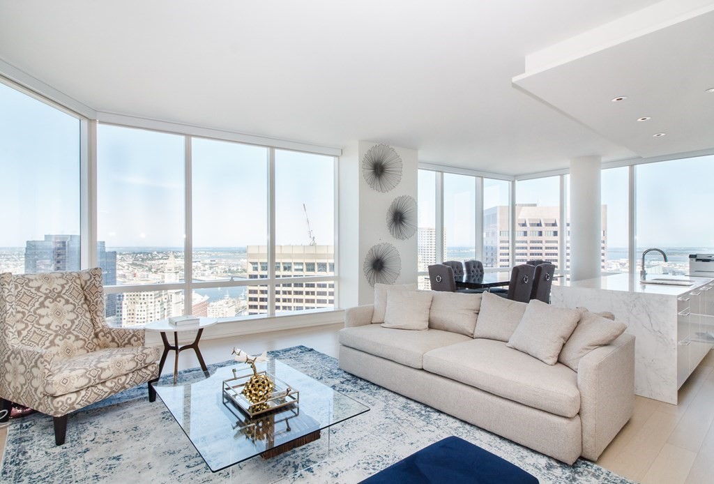 1 Franklin Street, Unit 5205 Boston, MA 02110 - Photo 3 of 40 a living room with furniture and a large window