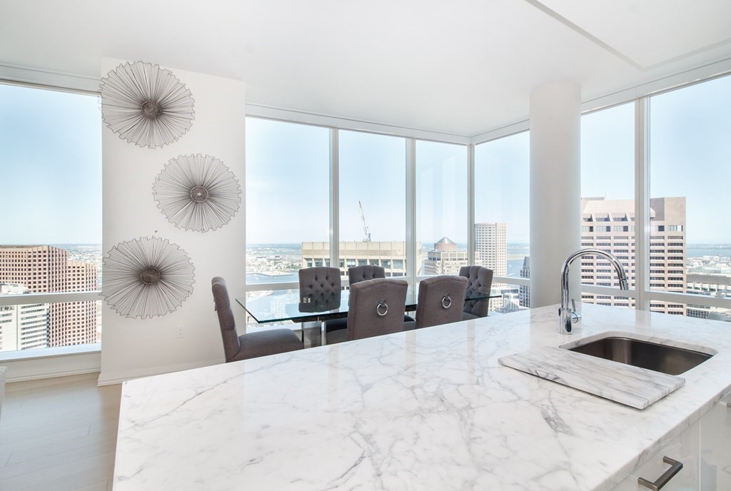 1 Franklin Street, Unit 5205 Boston, MA 02110 - Photo 7 of 40 a bedroom with a bed and a large window