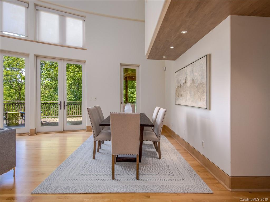 136 High Rock Ridge Drive Landrum, SC 29356 - Photo 22 of 44 a dining room with wooden floor and a rug