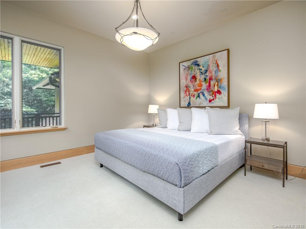 136 High Rock Ridge Drive Landrum, SC 29356 - Photo 29 of 44 a bedroom with a bed and a painting on the wall
