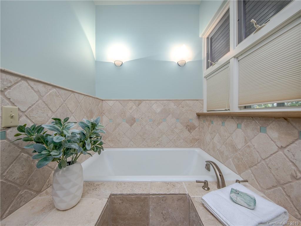 136 High Rock Ridge Drive Landrum, SC 29356 - Photo 32 of 44 a white bath tub sitting in a bathroom