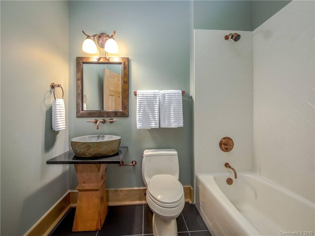 136 High Rock Ridge Drive Landrum, SC 29356 - Photo 34 of 44 a bathroom with a toilet sink and mirror