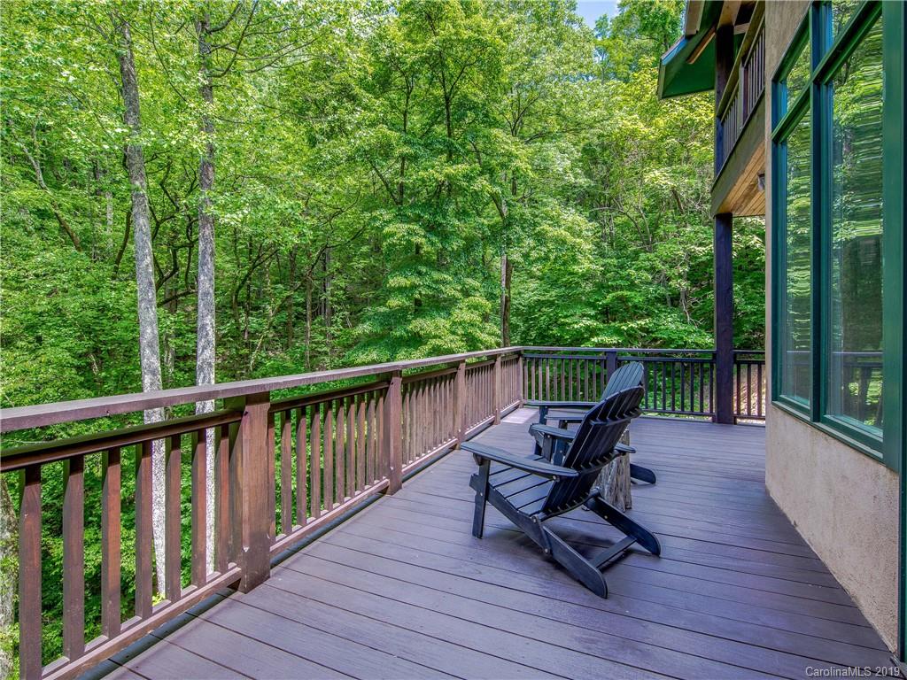 136 High Rock Ridge Drive Landrum, SC 29356 - Photo 41 of 44 a view of a balcony with wooden floor and outdoor seating
