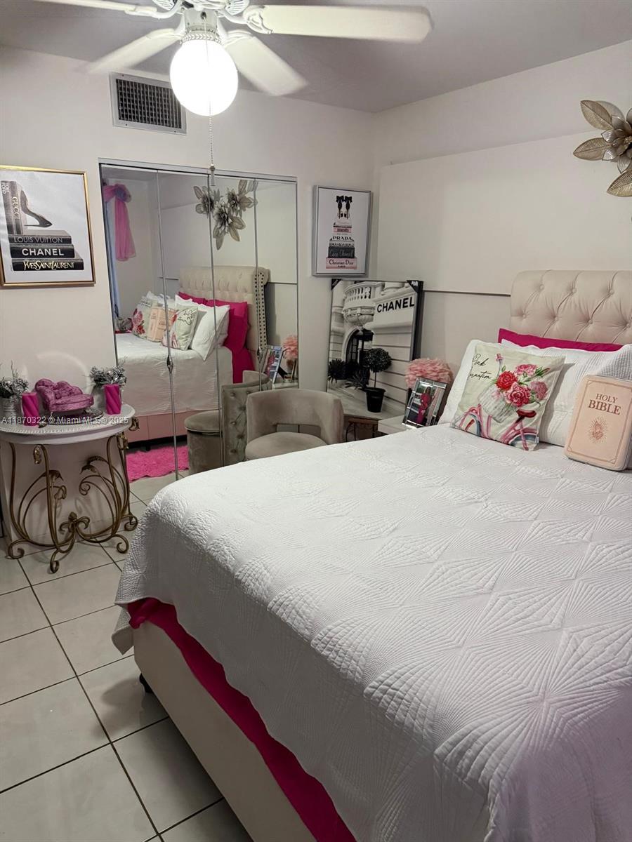 a bedroom with bed and cabinets