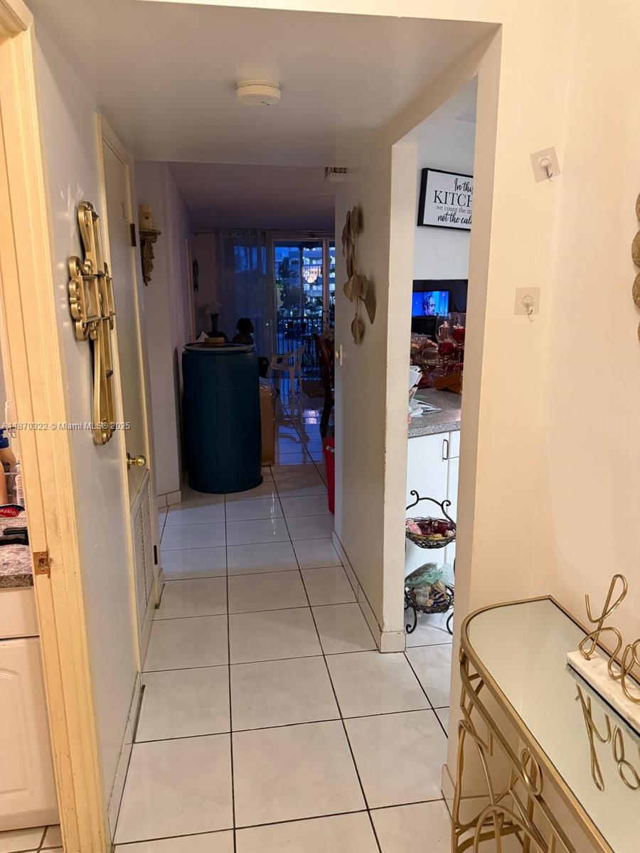 1710 Northeast 191st Street, Unit 3173 Miami, FL 33179 - Photo 11 of 18 a view of a storage & utility room with refrigerator and toys