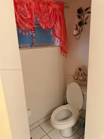 a white toilet sitting next to a shower