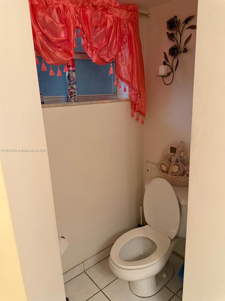 1710 Northeast 191st Street, Unit 3173 Miami, FL 33179 - Photo 13 of 18 a white toilet sitting next to a shower