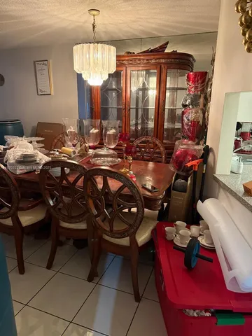 a room with furniture a chandelier and a mirror