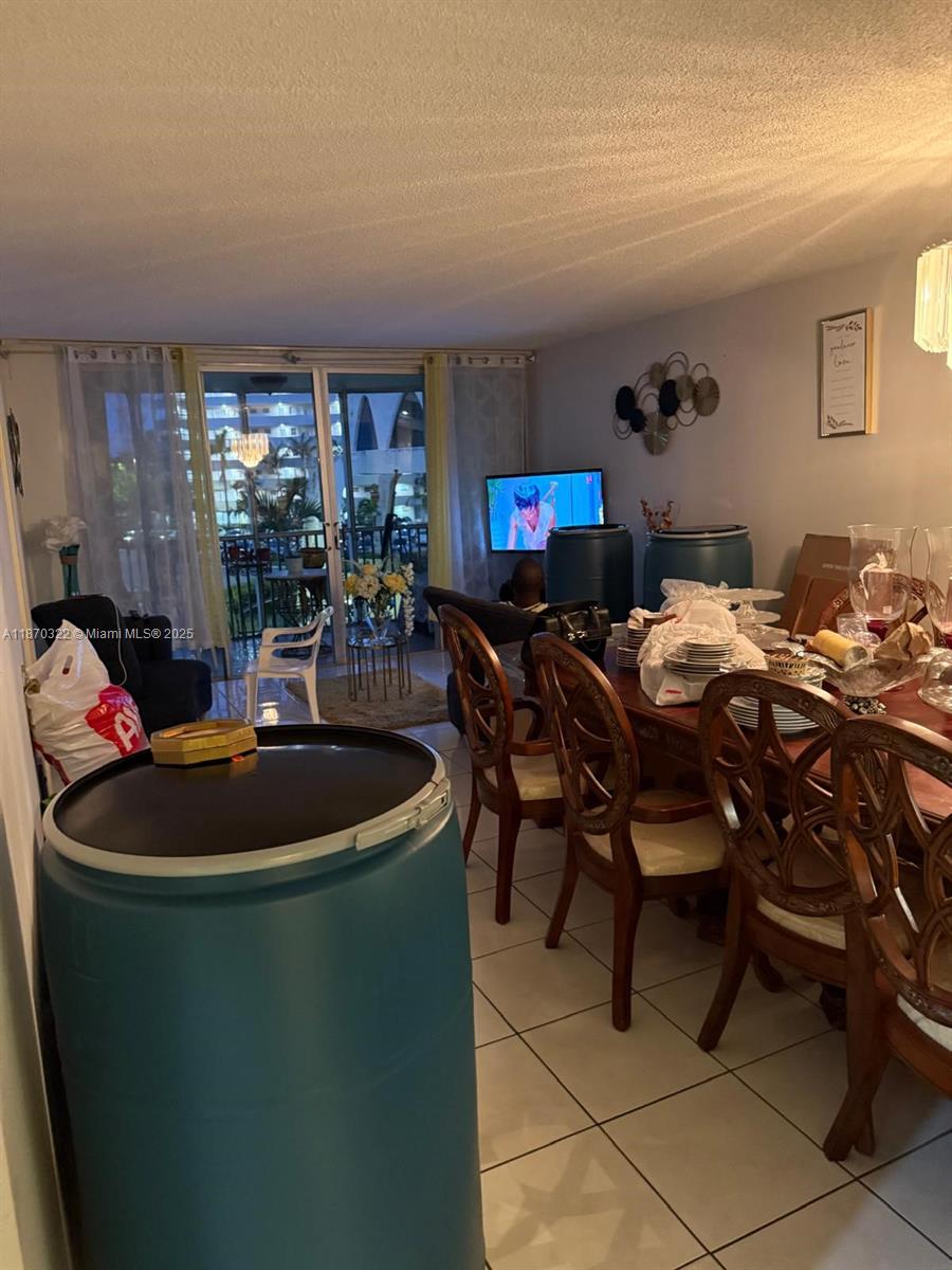 1710 Northeast 191st Street, Unit 3173 Miami, FL 33179 - Photo 17 of 18 a dinning table and chairs in a room