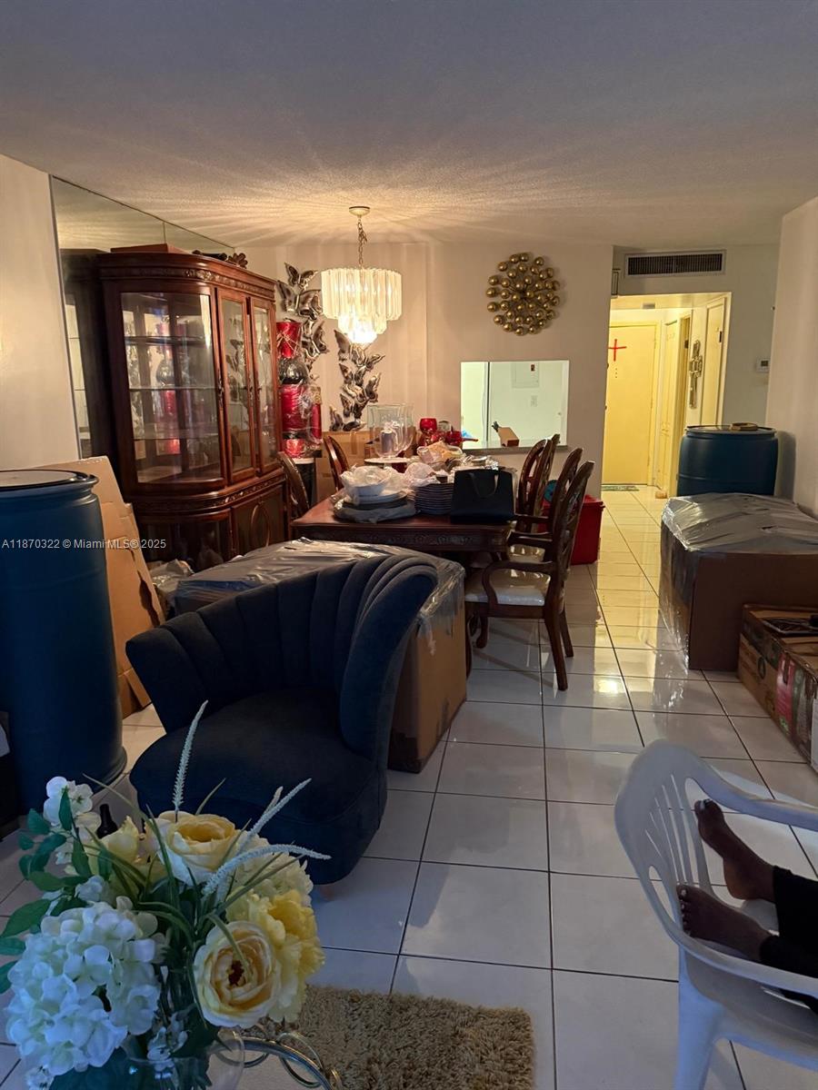 1710 Northeast 191st Street, Unit 3173 Miami, FL 33179 - Photo 3 of 18 a living room with furniture and a window