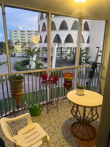 a view of a balcony with furniture