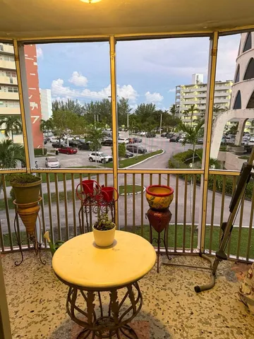 a view of a balcony with table and chairs