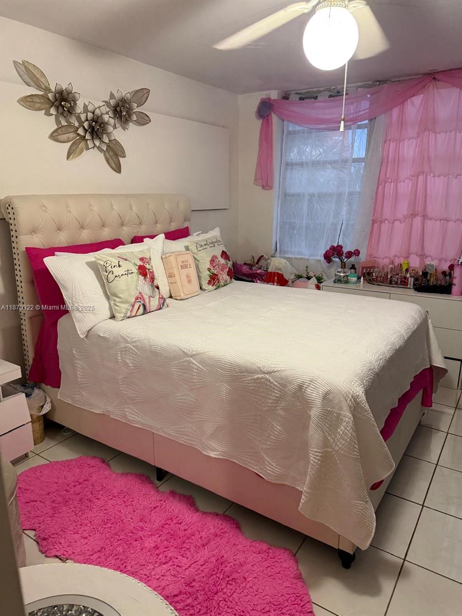 1710 Northeast 191st Street, Unit 3173 Miami, FL 33179 - Photo 8 of 18 a bedroom with a bed and a potted plant