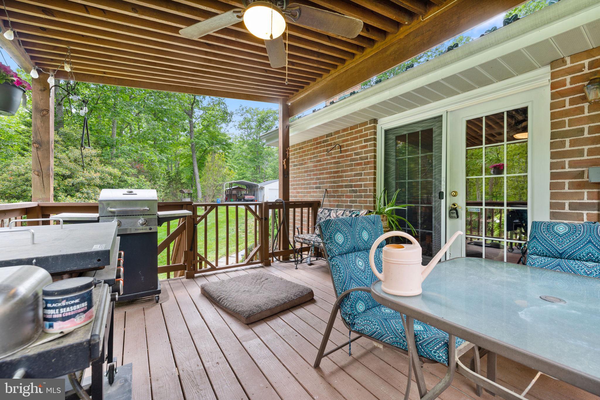 5099 Courtneys Corner Road Sumerduck, VA 22742 - Photo 19 of 52 a view of a deck with wooden floor and outdoor seating