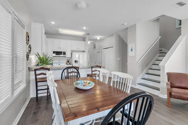 a kitchen with stainless steel appliances a sink a table and chairs
