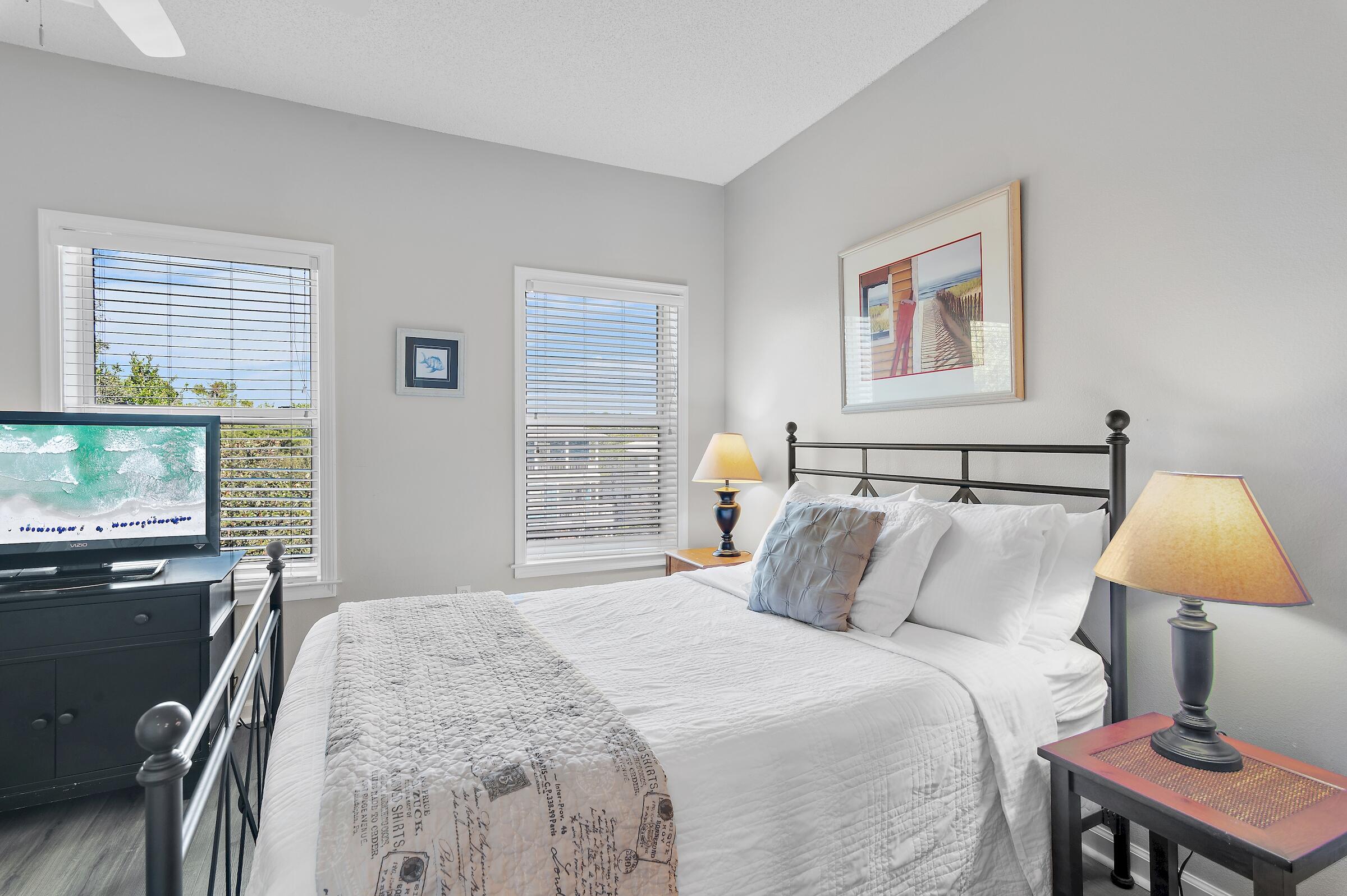 69 Seabreeze Trail Inlet Beach, FL 32461 - Photo 24 of 40 a bedroom with a bed lamps and window