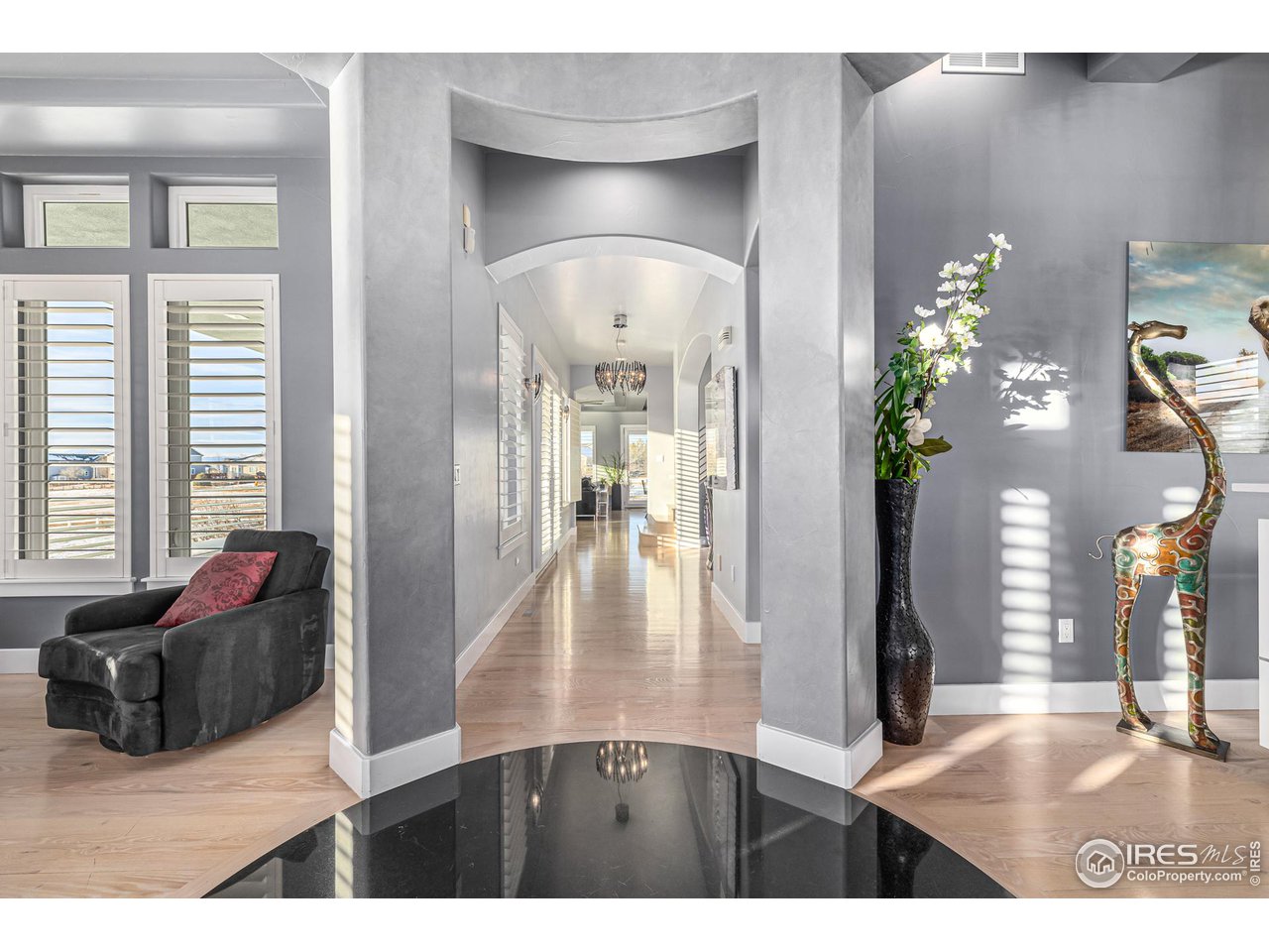 285 Commander Drive Erie, CO 80516 - Photo 11 of 40 a living room with furniture and a chandelier