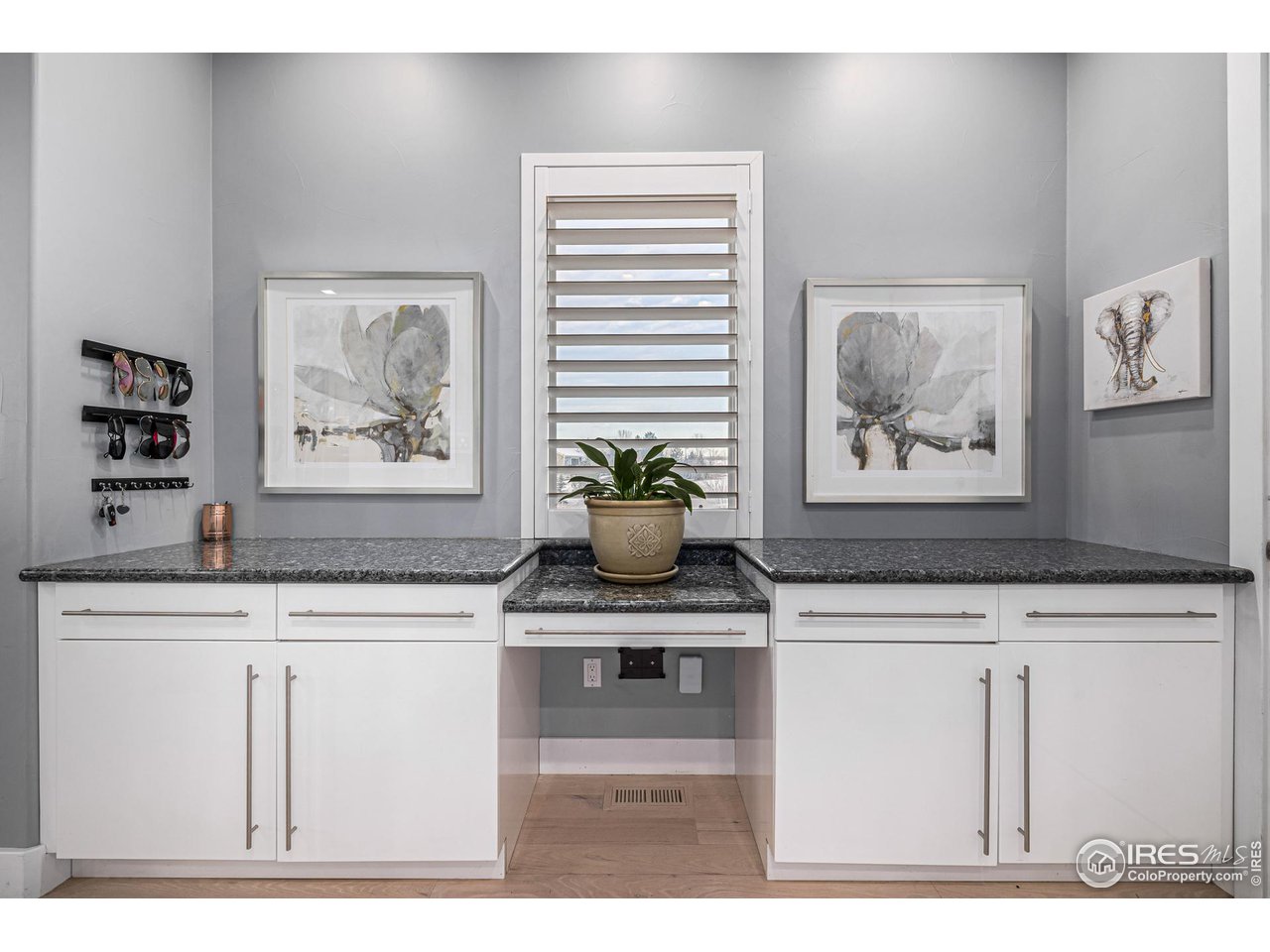 285 Commander Drive Erie, CO 80516 - Photo 18 of 40 a sink with a painting on the wall and a potted plant