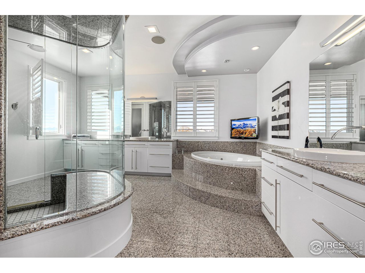 285 Commander Drive Erie, CO 80516 - Photo 24 of 40 a bathroom with a granite countertop tub sink and mirror