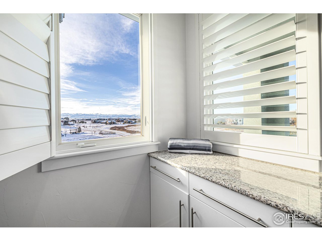 285 Commander Drive Erie, CO 80516 - Photo 25 of 40 a view of a bathroom with a granite countertop sink and a window