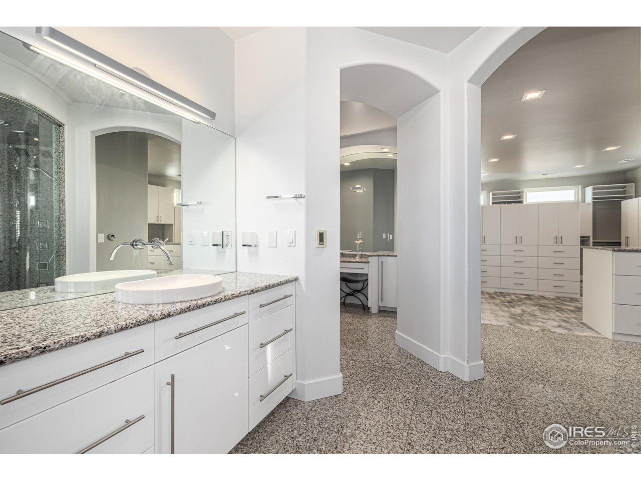 285 Commander Drive Erie, CO 80516 - Photo 28 of 40 a bathroom with a granite countertop sink mirror and shower