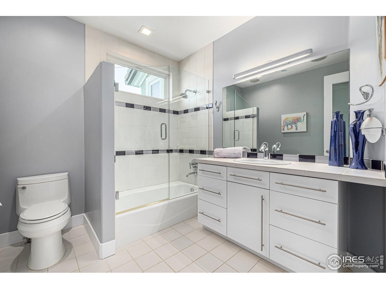 285 Commander Drive Erie, CO 80516 - Photo 29 of 40 a bathroom with a sink a toilet and a large mirror
