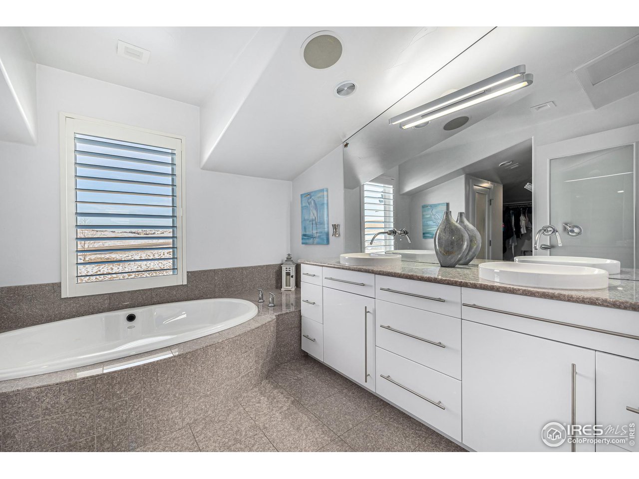 285 Commander Drive Erie, CO 80516 - Photo 31 of 40 a bathroom with a granite countertop tub sink and mirror