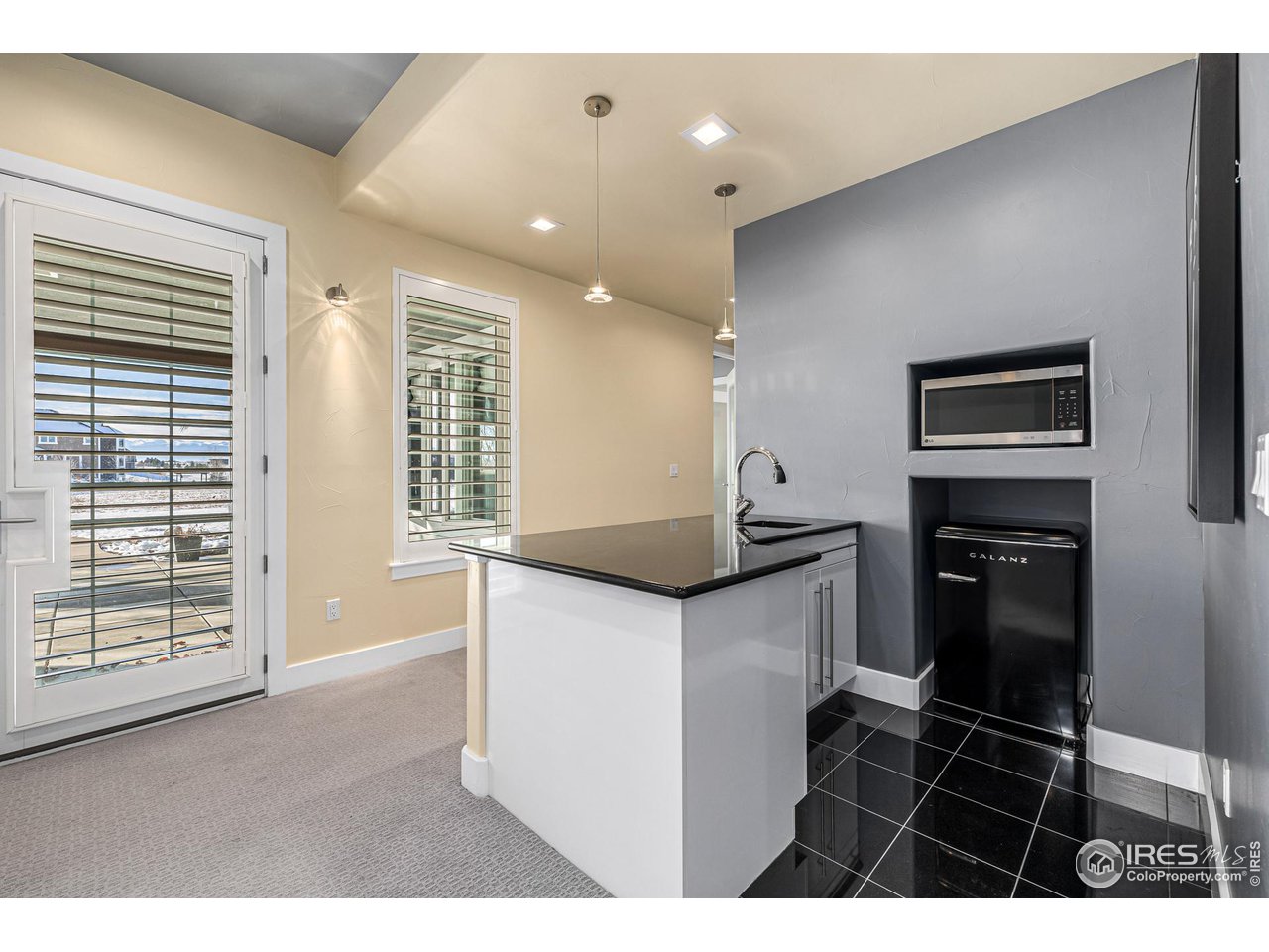285 Commander Drive Erie, CO 80516 - Photo 40 of 40 a kitchen with granite countertop a sink and a stove top oven