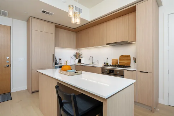 a kitchen with stainless steel appliances a stove a sink and a refrigerator