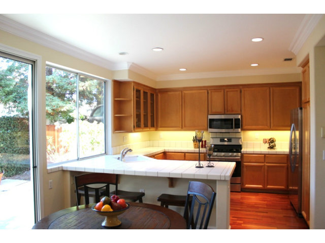 76 Images Circle Milpitas, CA 95035 - Photo 11 of 18 a kitchen with kitchen island sink cabinets and appliances