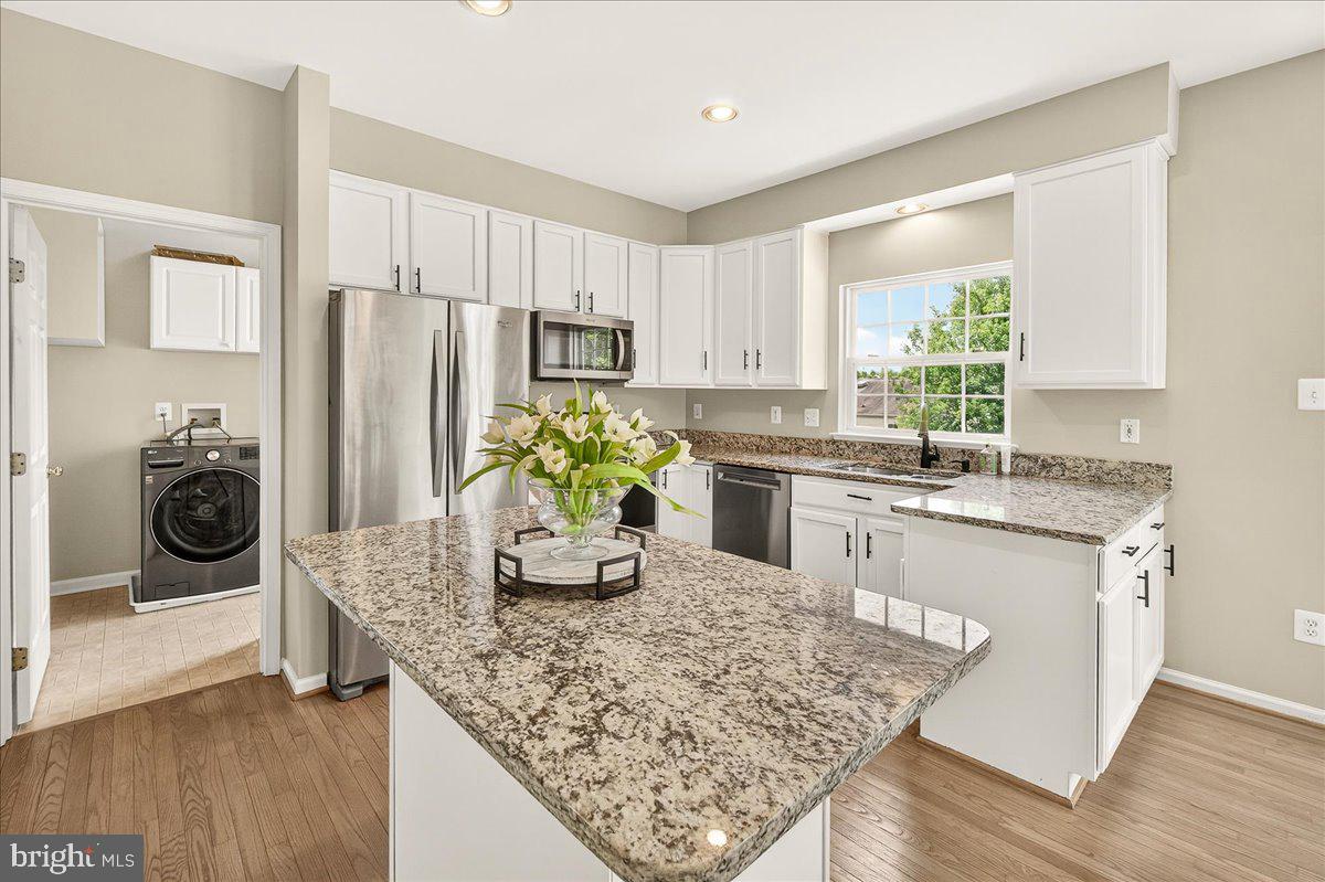 1308 Crossbow Road Mount Airy, MD 21771 - Photo 13 of 55 a kitchen with stainless steel appliances granite countertop a refrigerator sink and stove