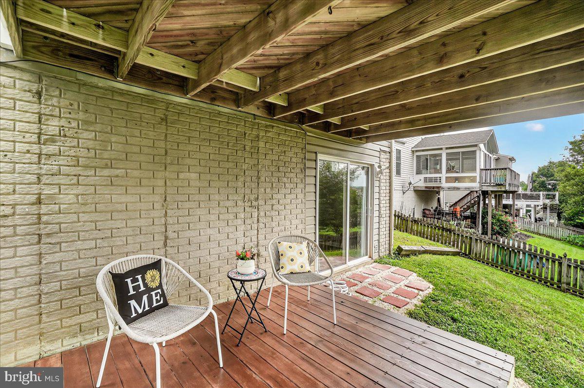 1308 Crossbow Road Mount Airy, MD 21771 - Photo 46 of 55 a view of a backyard with table and chairs with wooden floor and fence