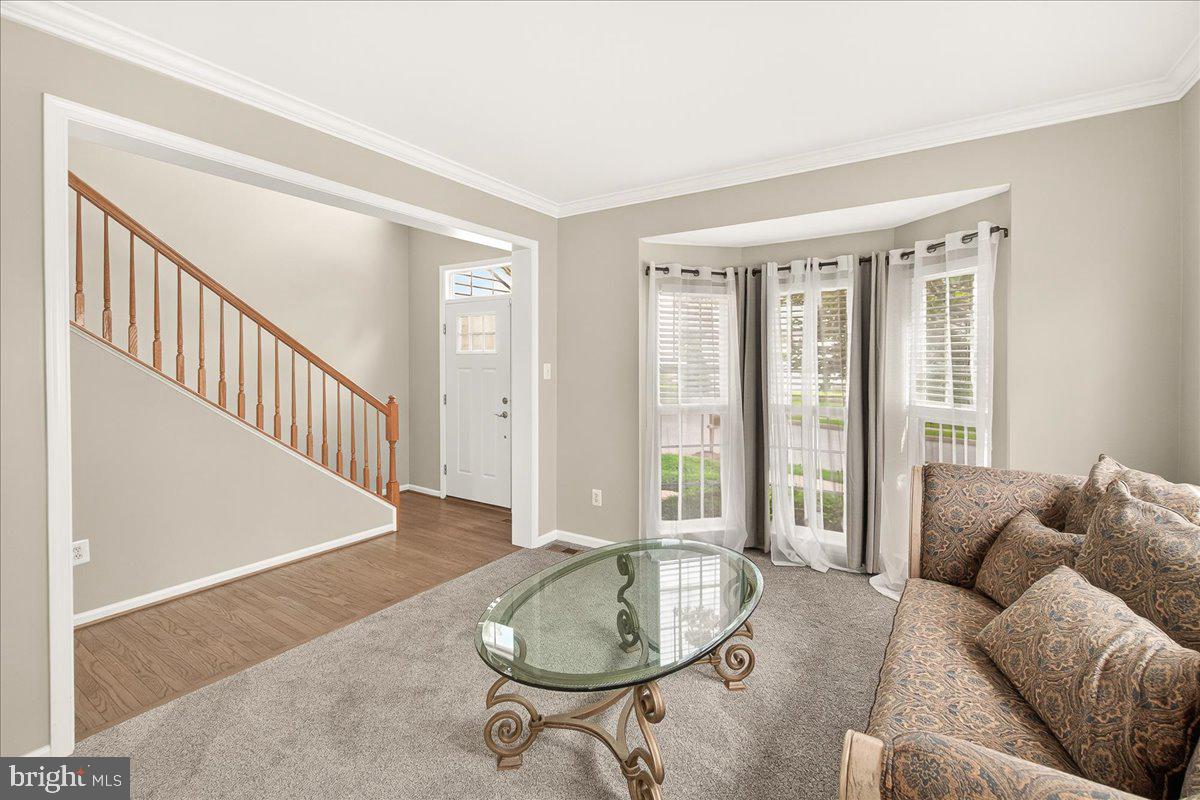 1308 Crossbow Road Mount Airy, MD 21771 - Photo 8 of 55 a living room with furniture and a table with wooden floor